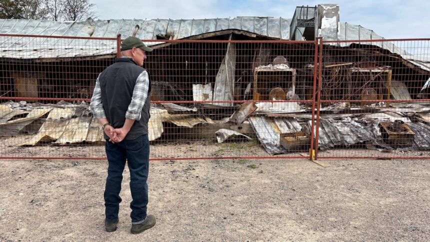 owner-of-robertson-trading-surveys-wildfire-damage-that-burned-historic-building-to-the-ground