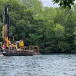 floating-barge-on-chocolate-lake-scoping-out-conditions-for-updated-dam