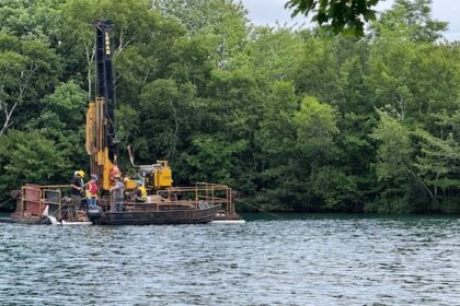 floating-barge-on-chocolate-lake-scoping-out-conditions-for-updated-dam