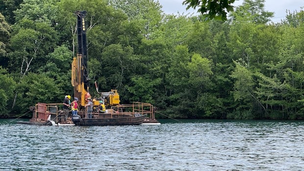 floating-barge-on-chocolate-lake-scoping-out-conditions-for-updated-dam