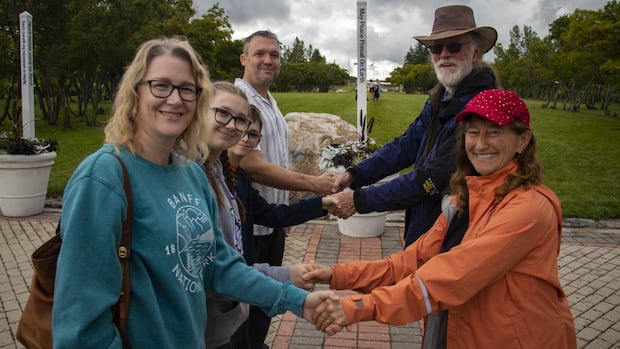 americans,-canadians-meet-at-international-peace-garden-for-handshake-across-the-border