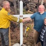 a-damaged-memorial-cross-rescued-from-the-long-lake-wildfire-is-back-where-it-belongs