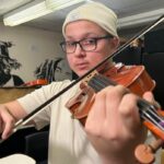 nb.-viola-player-tuning-up-for-performance-at-carnegie-hall