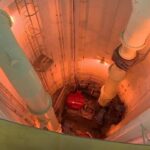 in-winnipeg,-a-distant-light-flickers-at-the-end-of-a-sewage-treatment-tunnel