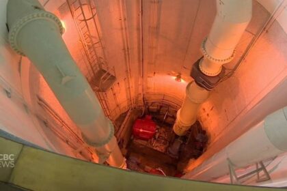 in-winnipeg,-a-distant-light-flickers-at-the-end-of-a-sewage-treatment-tunnel